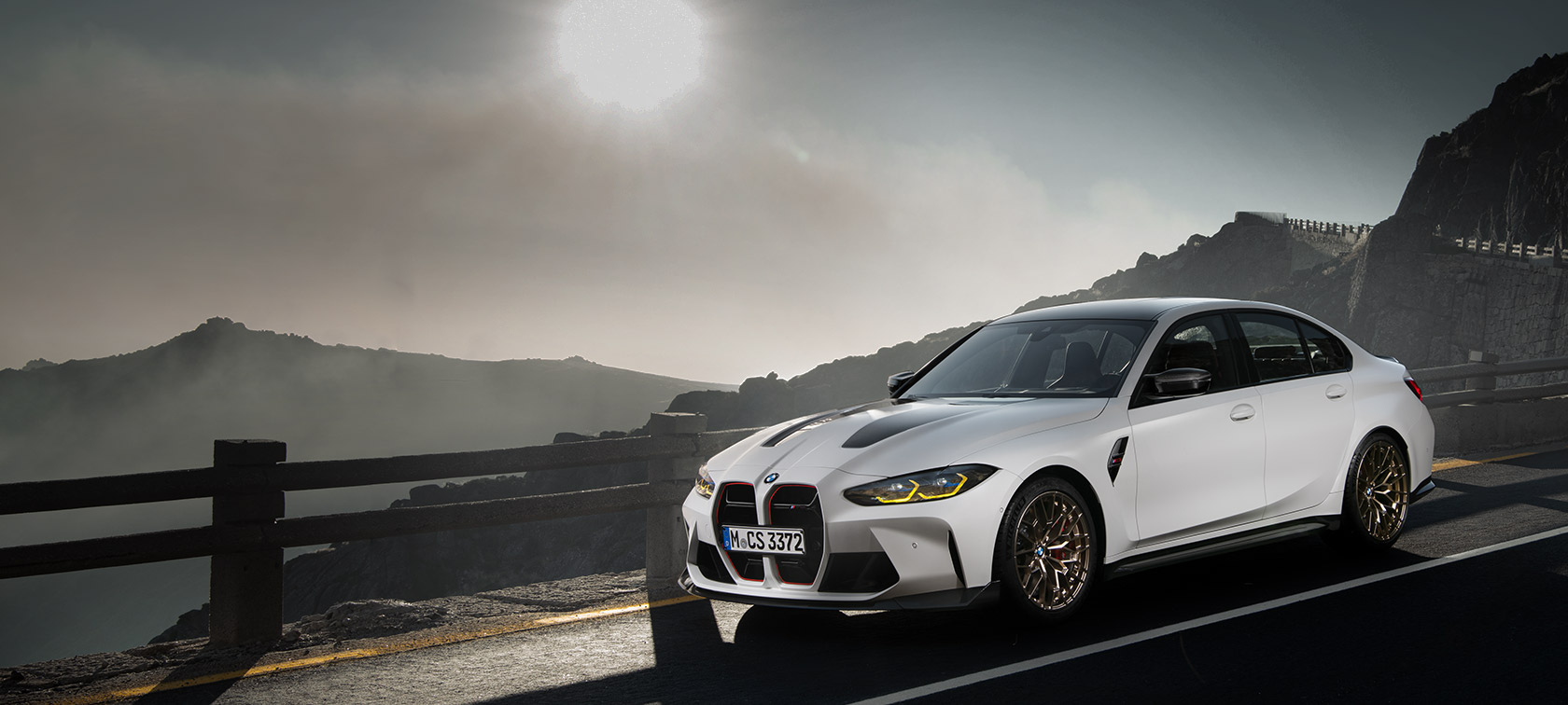 BMW M3 CS G80 side view driving on race track